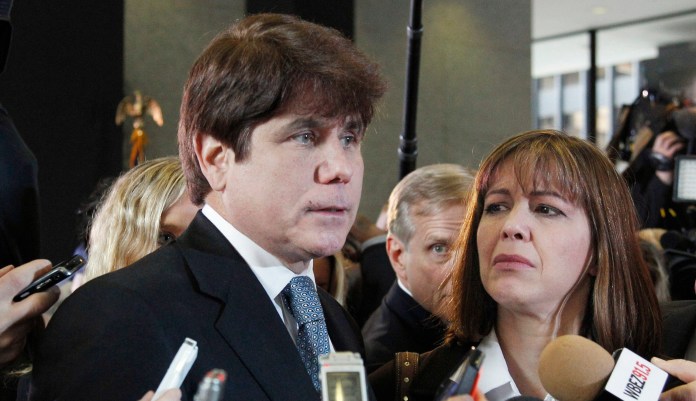 Former Illinois Gov. Rod Blagojevich, left, speaks to reporters as his wife, Patti, listens at the federal building in Chicago.
