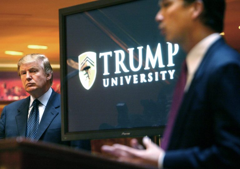 FILE- In this May 23, 2005 file photo, real estate mogul and Reality TV star, now Republican presidential candidate Donald Trump listens at left as Michael Sexton introduces him at a news conference in New York where he announced the establishment of Trump University. Facing the toughest stretch of her campaign, Hillary Clinton is trying to deflect attention back onto her rival Donald Trump, with a new push to highlight complaints surrounding his now-defunct Trump University, and allegations of pay-to-play involving Florida Attorney General Pam Bondi.