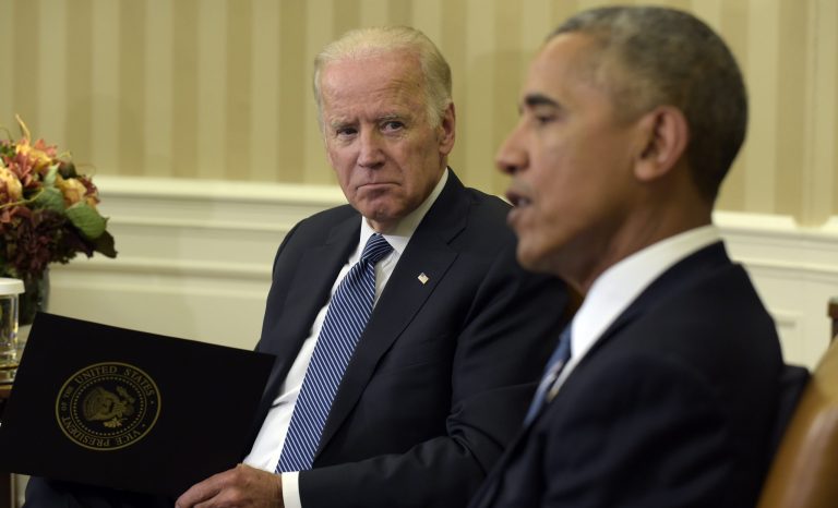 Vice President Joe Biden listens as President Barack Obama speaks in the Oval Office of the White House in Washington, Monday, Oct. 17, 2016.