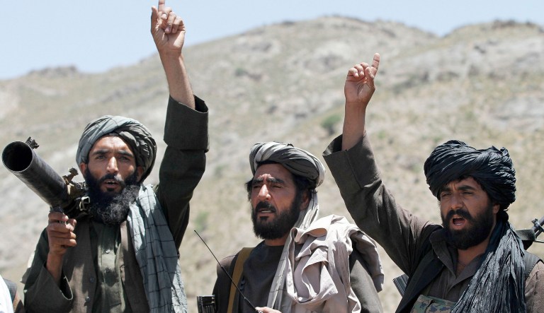 In this May 27, 2016 file photo, Taliban fighters react to a speech by their senior leader in the Shindand district of Herat province, Afghanistan.
