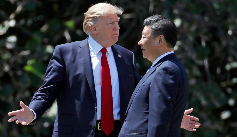 In this Friday, April 7, 2017, file photo, President Trump gestures as he and Chinese President Xi Jinping walk together at Mar-a-Lago in Palm Beach, Fla.