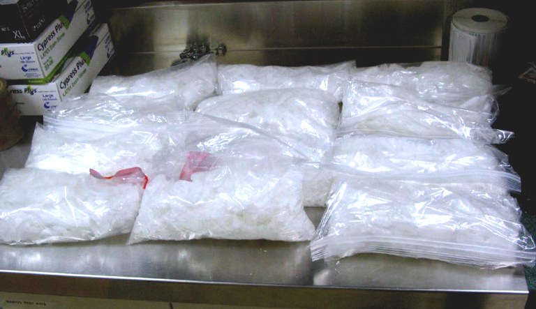 This undated photo provided by the U.S. Border Patrol shows 12 packages of methamphetamine that were confiscated from a U.S. citizen after a border patrol agent spotted a remote-controlled drone swooping over the border fence.