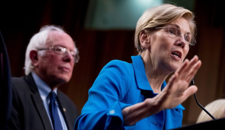 Sen. Elizabeth Warren, D-Mass., right, accompanied by Sen. Bernie Sanders, I-Vt., left, speaks during a news conference on Capitol Hill in Washington, Wednesday, Sept. 13, 2017, to unveil their Medicare for All legislation to reform health care.