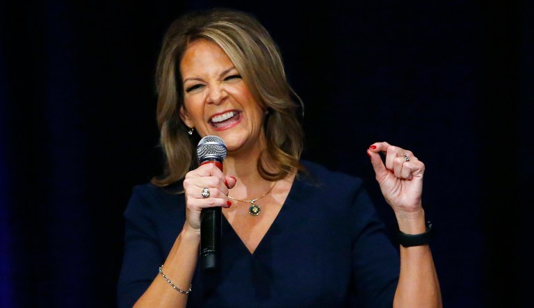 Former Republican Arizona state Sen. Kelli Ward smiles as she is greeted by supporters at a campaign fundraiser.