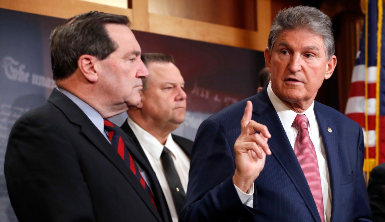 Sen. Joe Manchin, D-W.Va. (right), with Sen. Joe Donnelly, D-Ind. (left), and Sen. Jon Tester, D-Mont. (center), appear at a press conference.