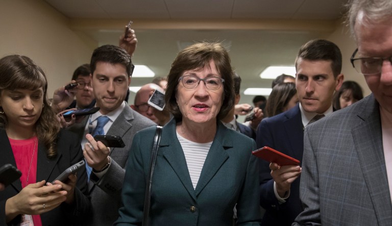 With reporters looking for updates, Sen. Susan Collins, R-Maine, and other senators rush through the hallways on Capitol Hill in Washington.