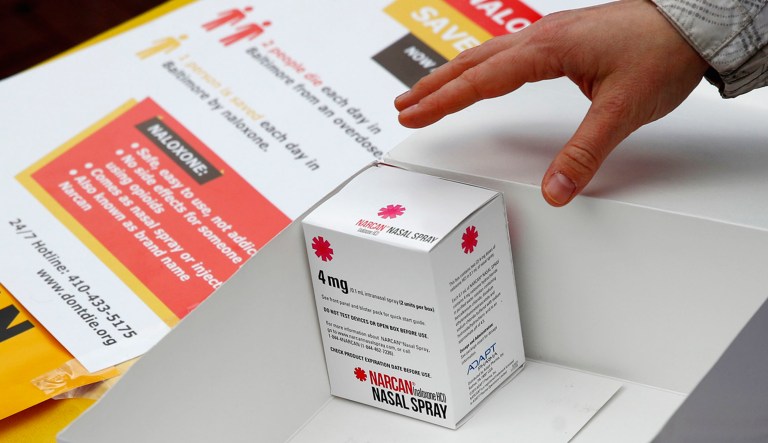 Kelleigh Eastman, a special projects director with the Baltimore City Health Department, reaches for a package of Narcan nasal spray in Baltimore.