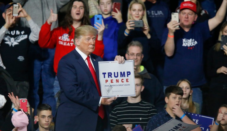 President Donald Trump, holds one of his campaign signs while leaving a campaign rally with Republican Rick Saccone, Saturday, March 10, 2018, in Moon Township, Pa. Saccone is running against Democrat Conor Lamb in a special election being held on March 13 for the Pennsylvania 18th Congressional District vacated by Republican Tim Murphy. 