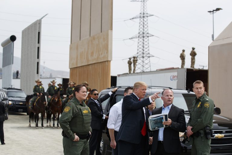 President Donald Trump reviews border wall prototypes, Tuesday, March 13, 2018, in San Diego.