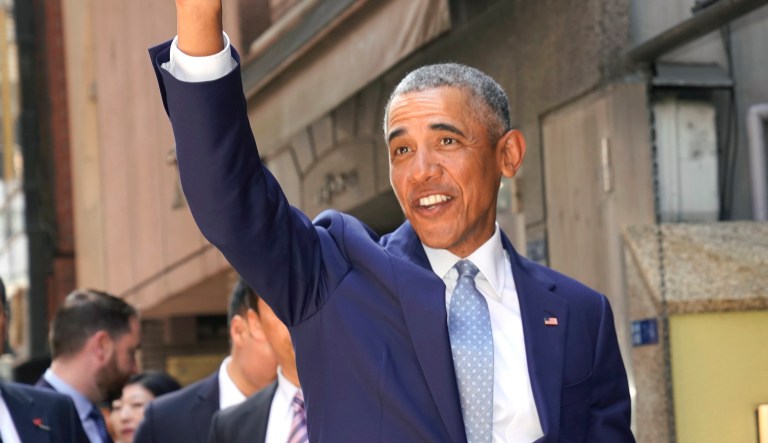 Former U.S. President Barack Obama waves as he and Japanese Prime Minister Shinzo Abe pose for photographers arrives at a Japanese Sushi restaurant in Tokyo's Ginza shopping district, Sunday, March 25, 2018. Obama says negotiations with North Korea on its nuclear weapons program are difficult, partly because the country's isolation minimizes possible leverage, such as trade and travel sanctions against Pyongyang. 