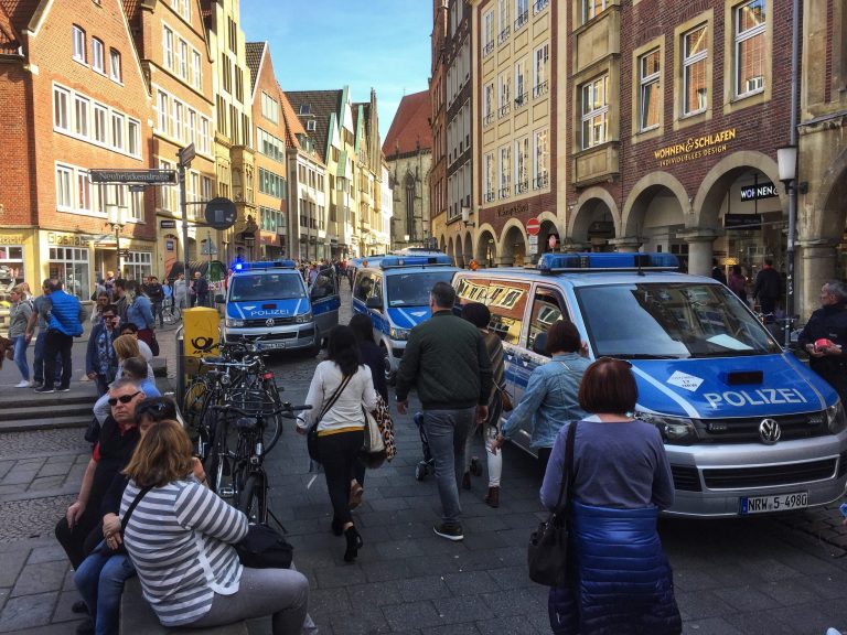 Police vans stand in downtown Muenster, Germany on Saturday. German news agency dpa says several people killed after car crashes into crowd in city of Muenster.