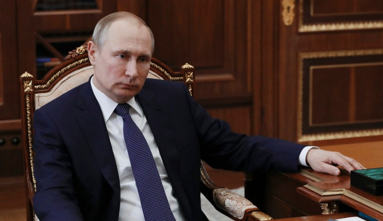 Russian President Vladimir Putin listens during a meeting with Agriculture Minister Alexander Tkachev in Moscow, Russia, Monday, April 9, 2018.