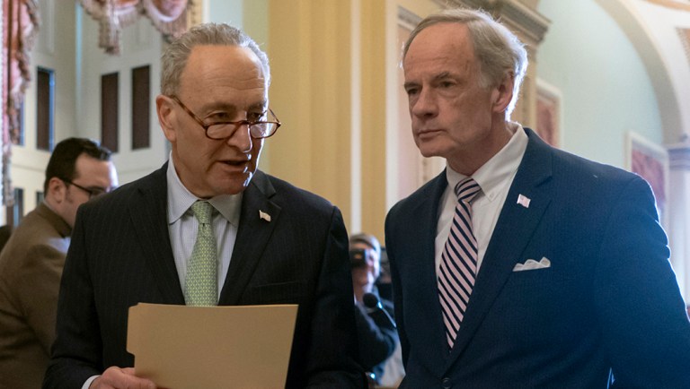 Senate Minority Leader Chuck Schumer, D-N.Y., and Sen. Tom Carper, D-Del., wraps up a news conference.