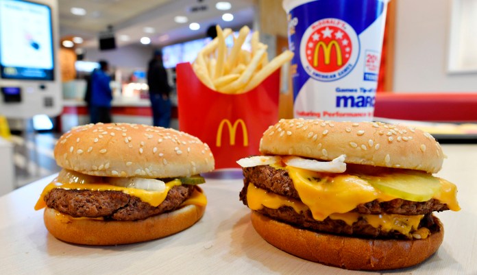 FILE- In this March 6, 2018, file photo, a McDonald's Quarter Pounder, left, and Double Quarter Pound burger is shown with fresh beef in Atlanta. McDonaldâs isnât ready to stop offering plastic straws, despite environmental concerns. A shareholder proposal to pressure the worldâs biggest hamburger chain on the matter was voted down at the companyâs annual meeting Thursday, May 24, 2018.