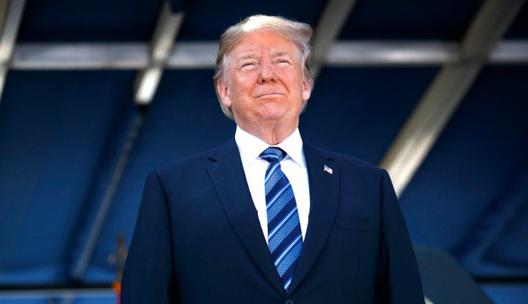 President Trump listens during a graduation and commissioning ceremony at the U.S. Naval Academy on Friday in Annapolis, Md.