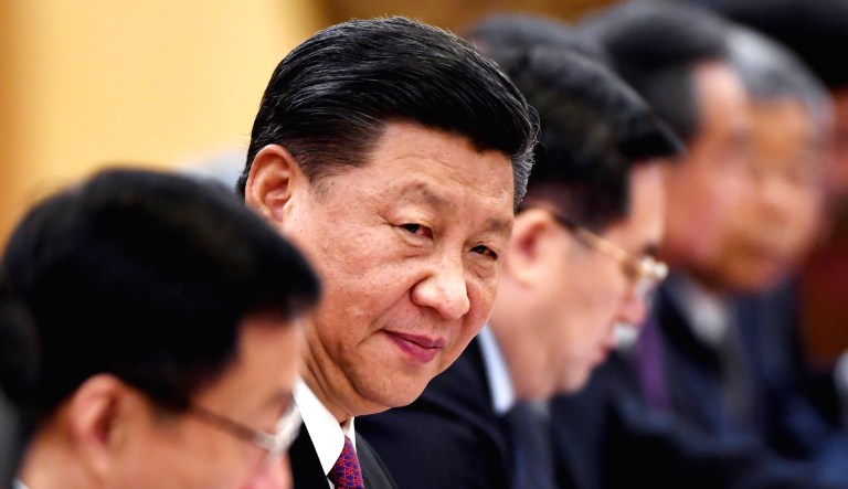 Chinese President Xi Jinping, second left, looks on during a meeting.