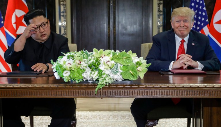 President Trump smiles after signing documents with North Korea leader Kim Jong Un  at the Capella resort on Sentosa Island in Singapore. 