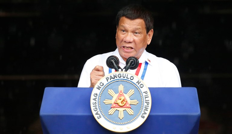 Philippine President Rodrigo Duterte gestures while addressing the crowd.