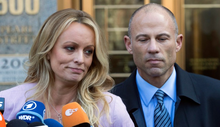 Porn star Stormy Daniels stands with her lawyer Michael Avenatti as she speaks outside federal court, in New York. 