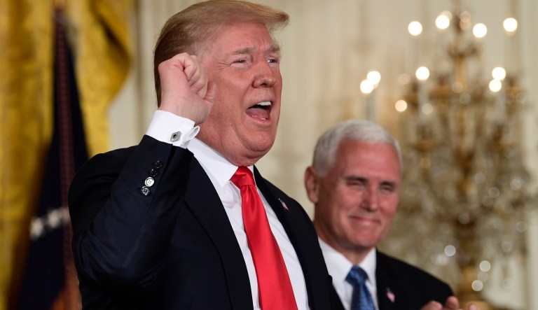 President Donald Trump speaks at the beginning of a National Space Council meeting in the East Room of the White House in Washington, Monday, June 18, 2018, as Vice President Mike Pence looks on.