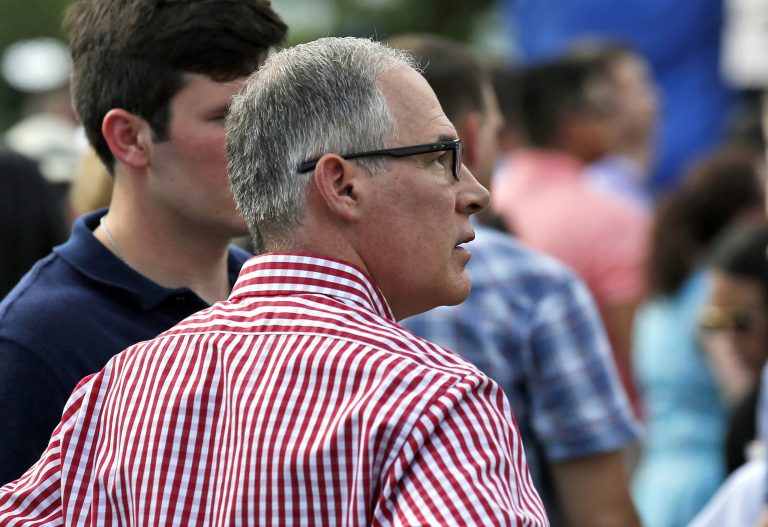 Environmental Protection Agency Administrator Scott Pruitt stands during an afternoon picnic for military families on the South Lawn of the White House, Wednesday, July 4. While he resigned the next day, a new report credits Pruitt for leading President Trump's war on Obama-era regulations.