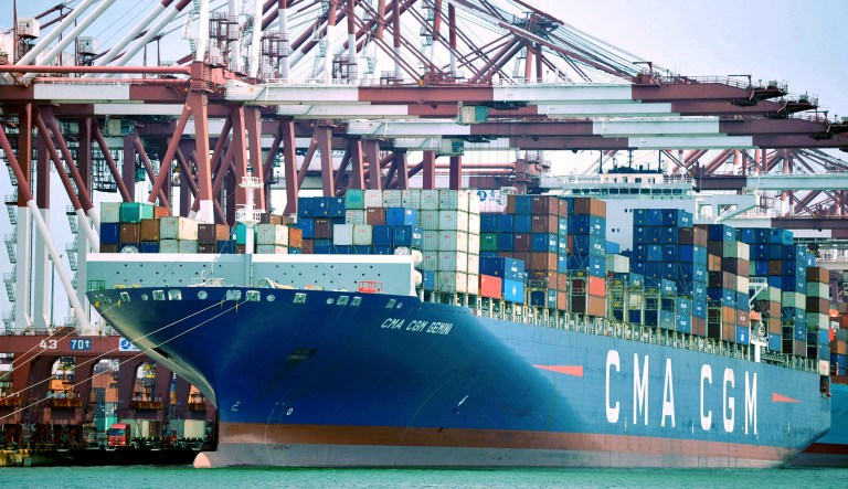 In this July 6, 2018, photo, a container ship is docked at a port in Qingdao in eastern China's Shandong Province. China's government on Wednesday, July 11, 2018, has criticized the latest U.S. threat of a tariff hike as "totally unacceptable" and vowed to retaliate in their escalating trade war. 