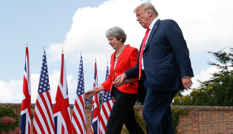 President Donald Trump and British Prime Minister Theresa May hold hands at the conclusion of their joint news conference at Chequers, in Buckinghamshire, England, Friday, July 13, 2018. 