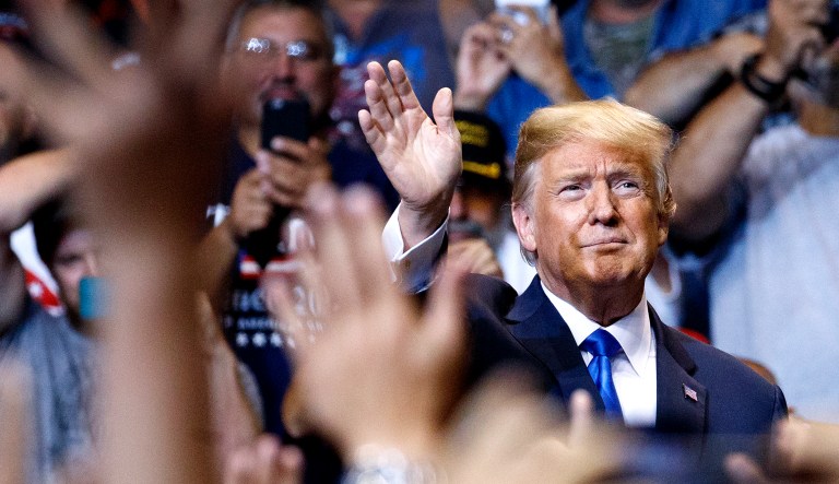 President Trump waves to the cheering crowd as he arrives for a political rally in Wilkes Barre, Pa.