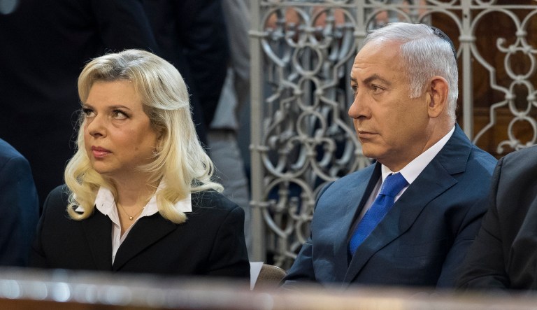 Israeli Prime Minister Benjamin Netanyahu, center, his wife Sara Netanyahu and Lithuania's Minister of Foreign Affairs Linas Linkevicius, sit during their visit to the synagogue in Vilnius, Lithuania, Sunday, Aug. 26, 2018.