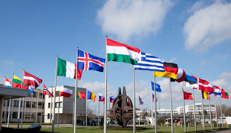 Flags flutter in the wind in front of NATO headquarters in Brussels.