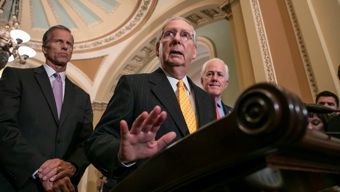 Senate Majority Leader Mitch McConnell, R-Ky., flanked by Sen. John Thune, R-S.D., left, and Majority Whip John Cornyn, R-Texas, speaks with reporters following their weekly policy meetings.