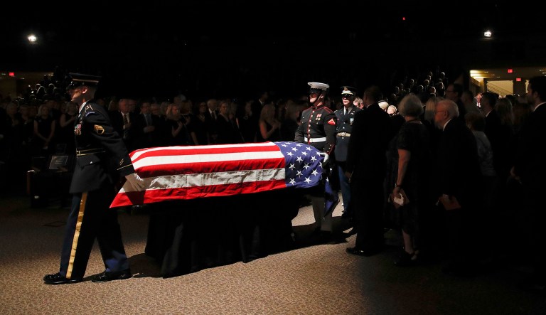 The military honor guard moves the casket into the North Phoenix Baptist Church for a memorial service for Sen. John McCain.