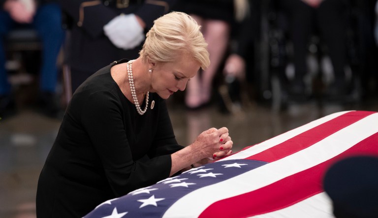 Cindy McCain, wife of Sen. John McCain, R-Ariz., leans on his flag-draped casket during a farewell ceremony in the U.S. Capitol rotunda, Friday, Aug. 31, 2018, in Washington. McCain was a six-term senator, a former Republican nominee for president, and a Navy pilot who served in Vietnam, where he endured five-and-a-half years as a prisoner of war. He died Aug. 25 from brain cancer at age 81.