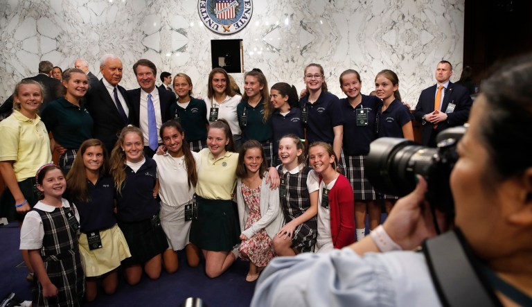 Brett Kavanaugh stands with Sen. Orrin Hatch, R-Utah, and girls who he has coached in basketball, including his daughters Liza, bottom left, and Margaret, second from top right. 