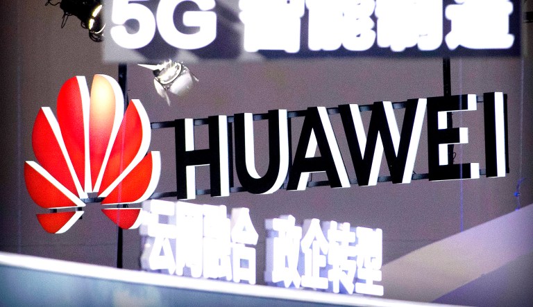 Signs promoting 5G wireless technology from Chinese technology firm Huawei are displayed at the PT Expo in Beijing.