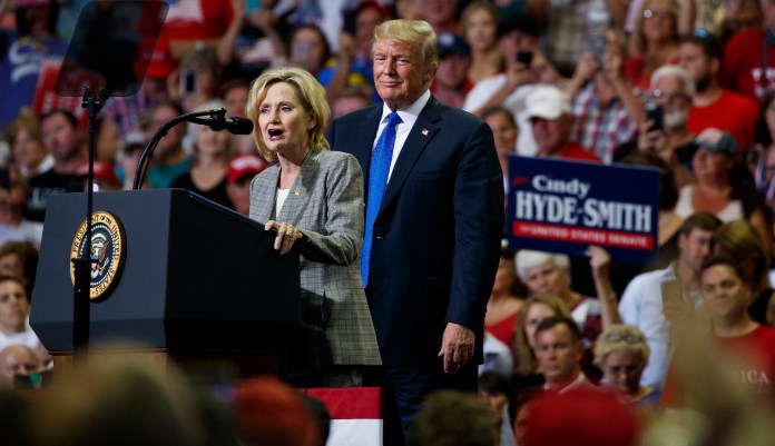 President Donald Trump watches as Sen. Cindy Hyde-Smith, R-Miss., speaks during a campaign rally at the Landers Center Arena, Tuesday, Oct. 2, 2018, in Southaven, Miss.