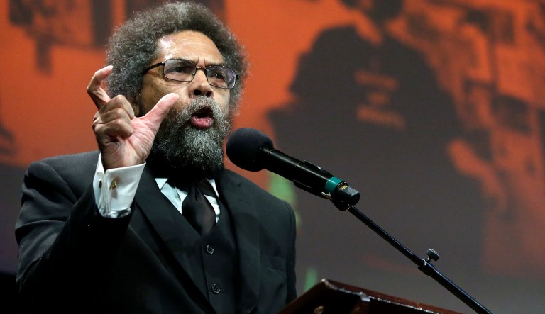 Harvard professor and philosopher Cornel West, left, address an audience in front of a projected image of former NFL football quarterback Colin Kaepernick,  before presenting Kaepernick with the W.E.B. Du Bois Medal during ceremonies, Thursday, Oct. 11, 2018, at Harvard University, in Cambridge, Mass. Kaepernick is among eight recipients of Harvard University's W.E.B. Du Bois Medals in 2018. Harvard has awarded the medal since 2000 to people whose work has contributed to African and African-American culture.