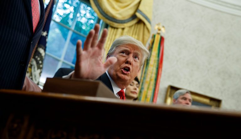 In this Oct. 11, 2018, file photo President Trump talks with reporters in the Oval Office of the White House, in Washington. 