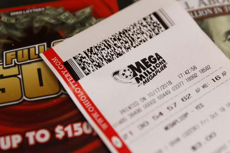 A Mega Millions lottery ticket rests on the shop counter at the Street Corner Market, Wednesday, Oct. 17, 2018, in Cincinnati. The estimated jackpot for Friday's drawing would be the second-largest lottery prize in U.S. history with a jackpot estimated to exceed $900 million.