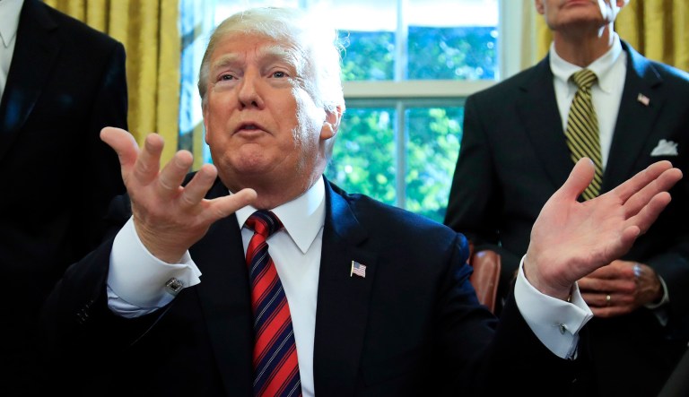 President Donald Trump speaks to reporters in the Oval Office at the White House in Washington, Tuesday, Oct. 23, 2018.