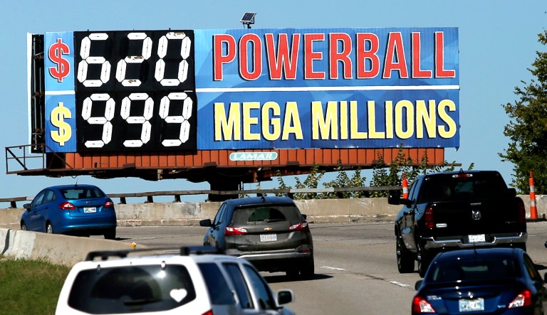 Drivers on the Broken Arrow Expressway pass a sign with the Powerball and Mega Millions jackpot numbers as they drive toward downtown Tulsa, Okla.
