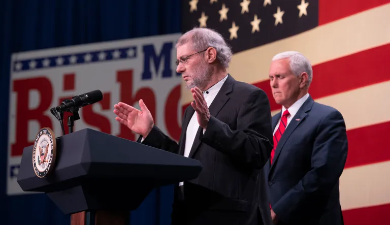 Invited on stage by Vice President Mike Pence, right, Rabbi Loren Jacobs, of congregation Shema Yisrael, says a prayer during a rally featuring GOP political candidates and Vice President Mike Pence at the Oakland County airport, in Waterford, Monday, October 29, 2018.