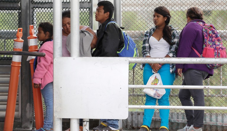 Immigrants seeking asylum in the United States wait on the the International Bridge, Saturday, Nov. 3, 2018, in Reynosa, Mexico.