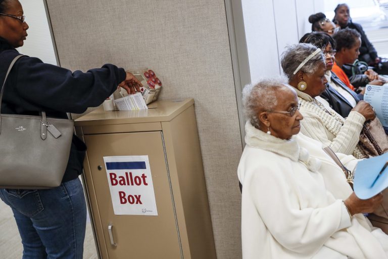 Voters go to the polls during early voting at the Hamilton County Board of Elections, Sunday, Nov. 4, 2018, in Cincinnati.