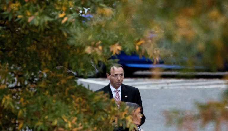 Deputy Attorney General Rod Rosenstein waits for his car as he departs the West Wing of the White House in Washington, Wednesday, Nov. 7, 2018.