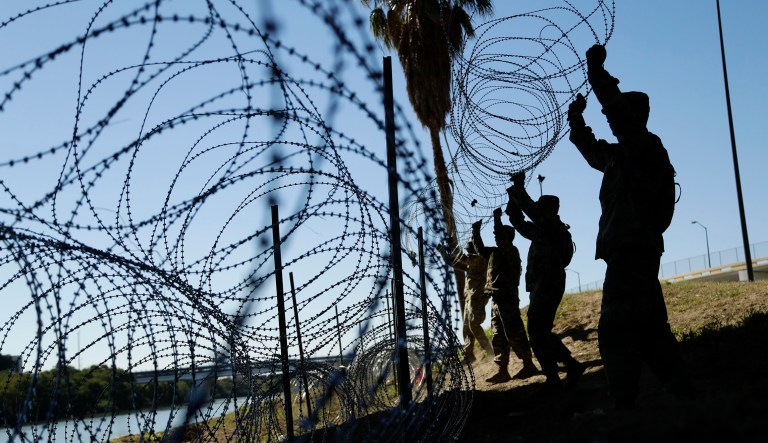 Members of the U.S. military install multiple tiers of concertina wire along the banks of the Rio Grande near the Juarez-Lincoln Bridge at the U.S.-Mexico border, Friday, Nov. 16, 2018, in Laredo, Texas.