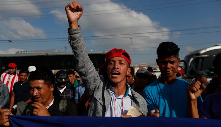 A Honduran migrant chants slogans during a demonstration outside the U.S. consulate in Tijuana, Mexico, Tuesday, Dec. 11, 2018. Migrants want U.S. authorities to speed up the asylum application process for members of migrant caravans seeking to enter the U.S., including accepting more applications per day.