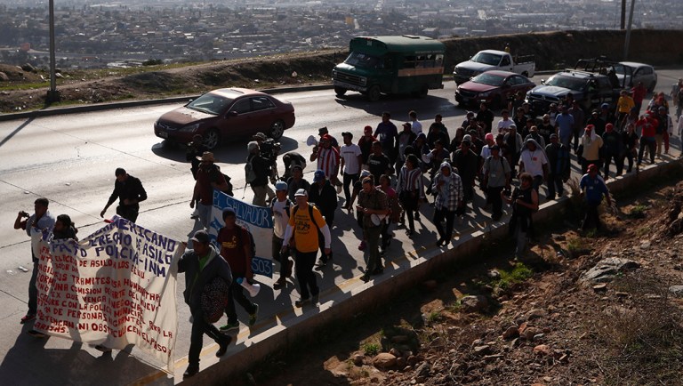 Central American migrants march to the U.S. consulate in Tijuana, Mexico.