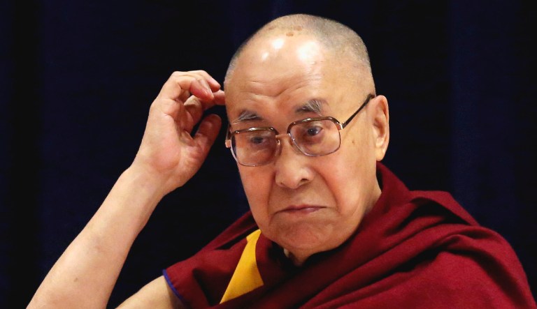 Tibetan spiritual leader the Dalai Lama gestures as he speaks at an event.