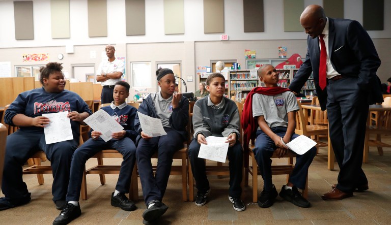 Jamar McKneely, CEO of InspireNOLA Charter Schools (pictured right), talks with students at Alice M. Harte Charter School in New Orleans.